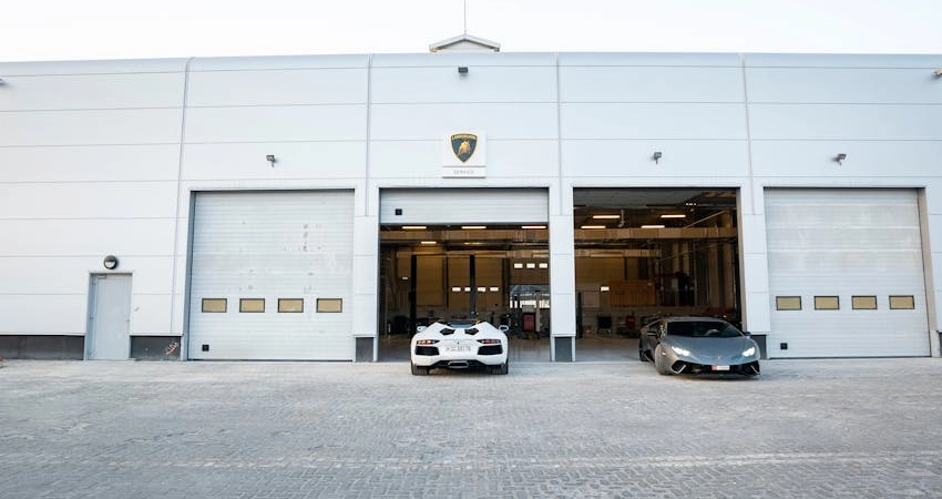Exterior view of a luxury auto repair shop featuring garage doors
