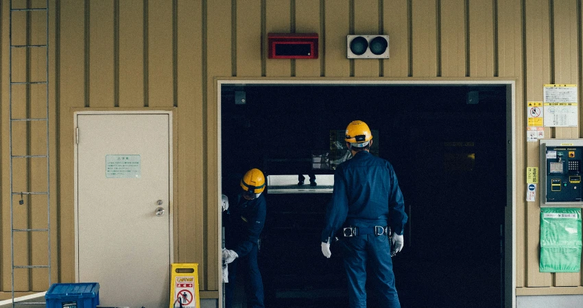 Garage door professionals inspecting a garage door