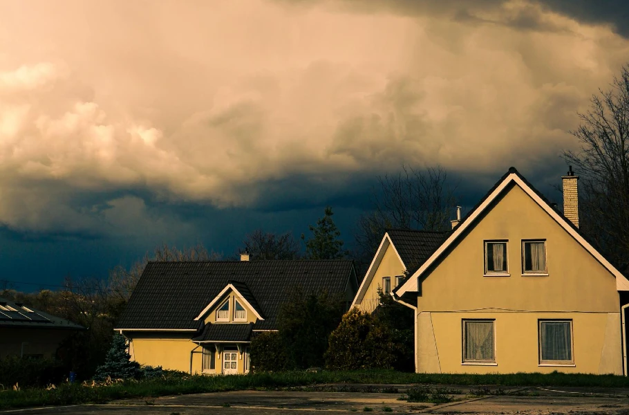 Severe storm clouds approaching homes with garage doors