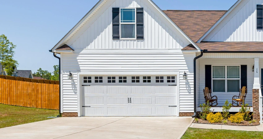 White house with a garage door.