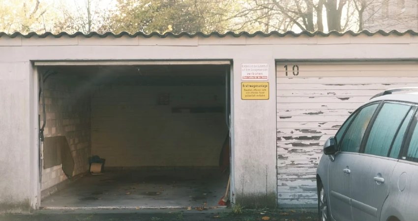 a car parked in front of a white building