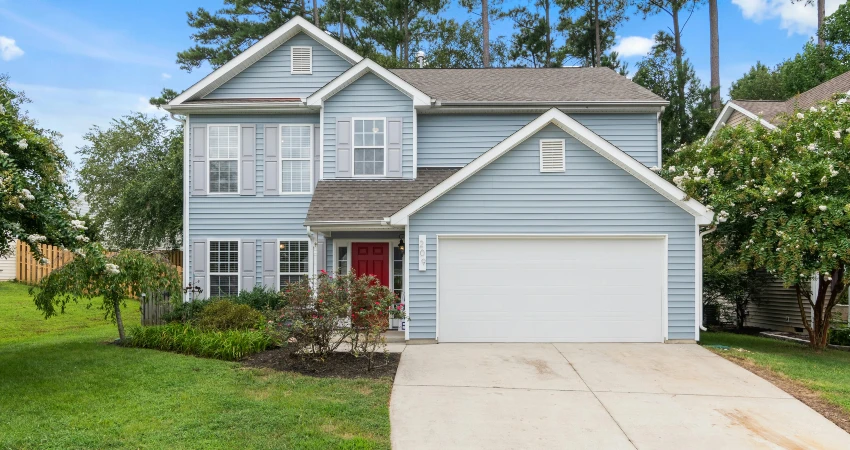 aesthetic appeal of a blue house with white insulated garage door