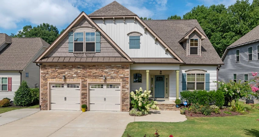 beautiful house with a white garage doors