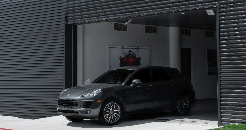 black car exiting a garage