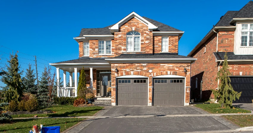 brown and white concrete house under blue sky