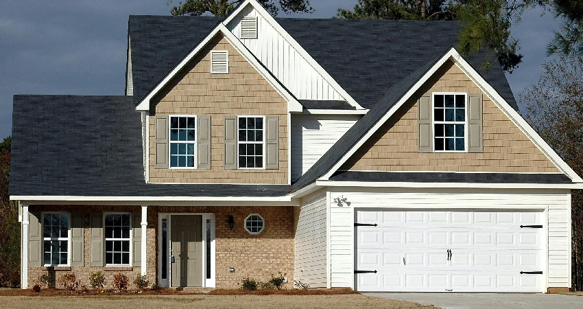 brown house with a white garage door replacement