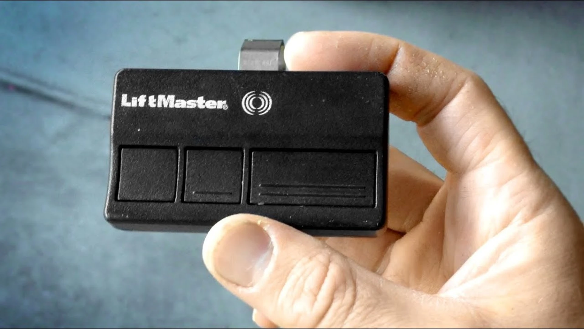 What is the process for changing the battery in a LiftMaster garage door opener?