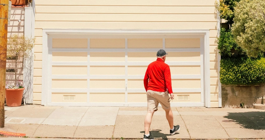 man walking toward garage door