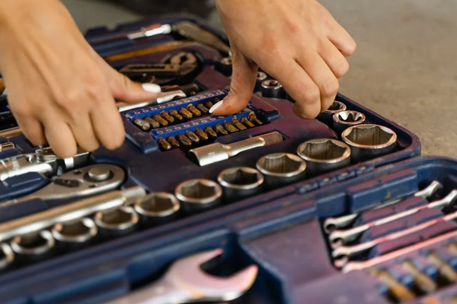 person touching tools in a tool box