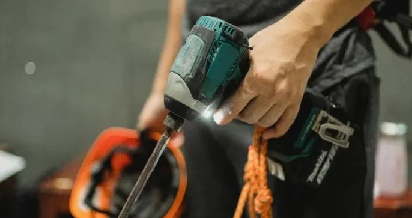 professional holding screwdriver for garage door installation