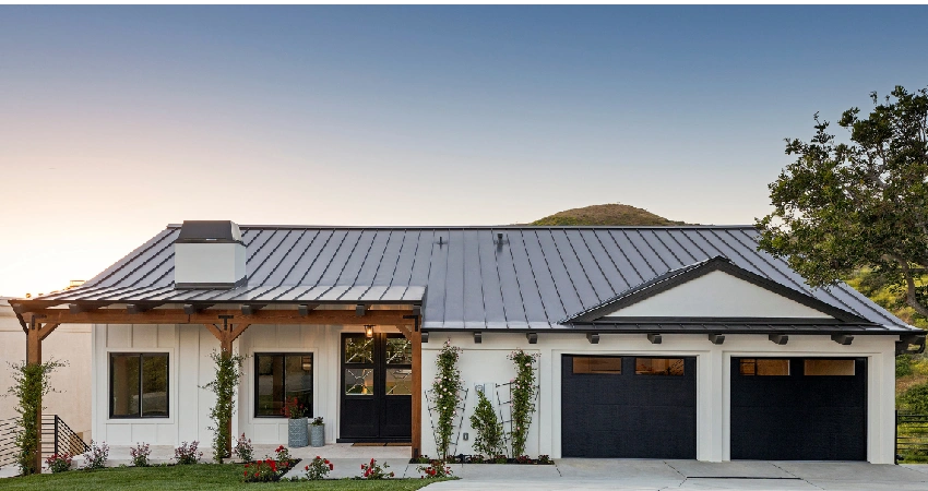 white and gray house with closed garage door