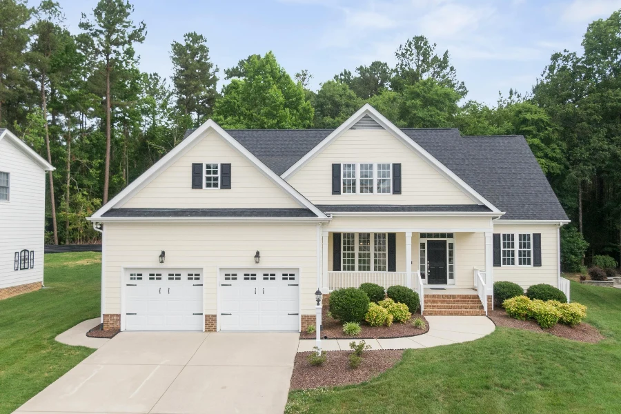 white house with front yard and white garage door panels