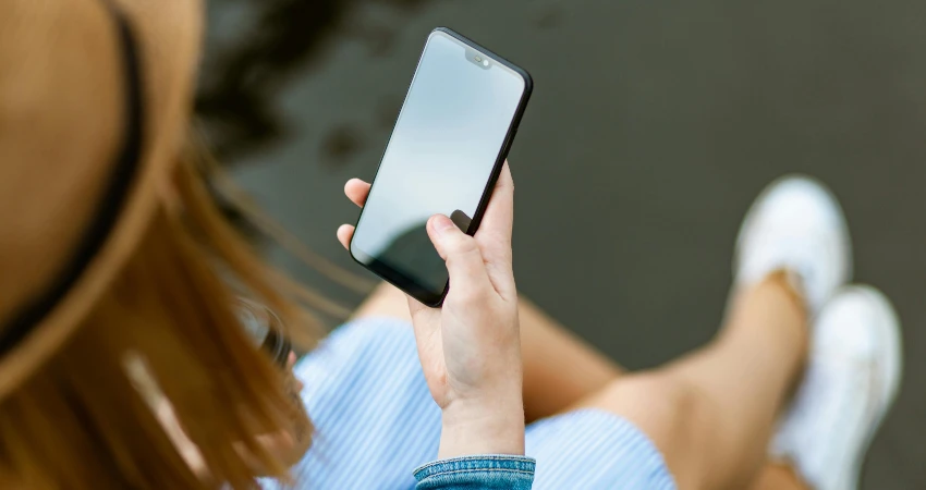 woman locking her garage door from her phone